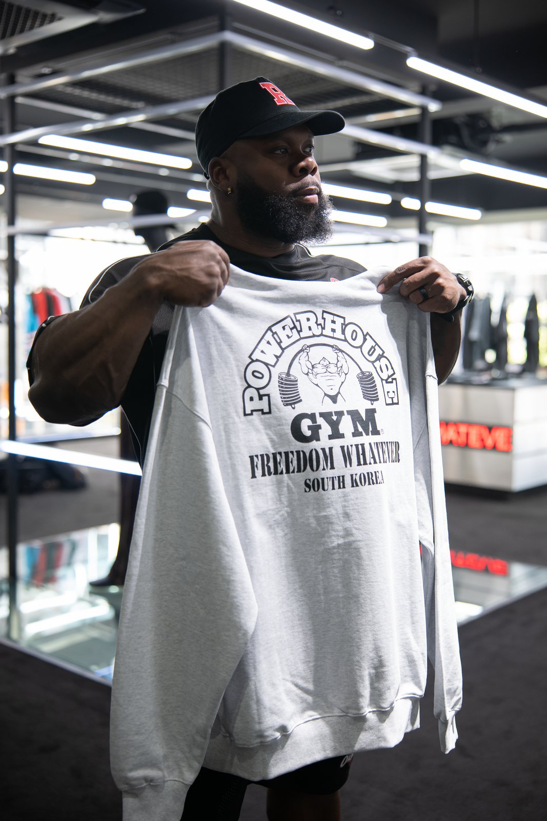 Keone Pearson holding a Powerhouse Gym Freedom Whatever South Korea T-shirt